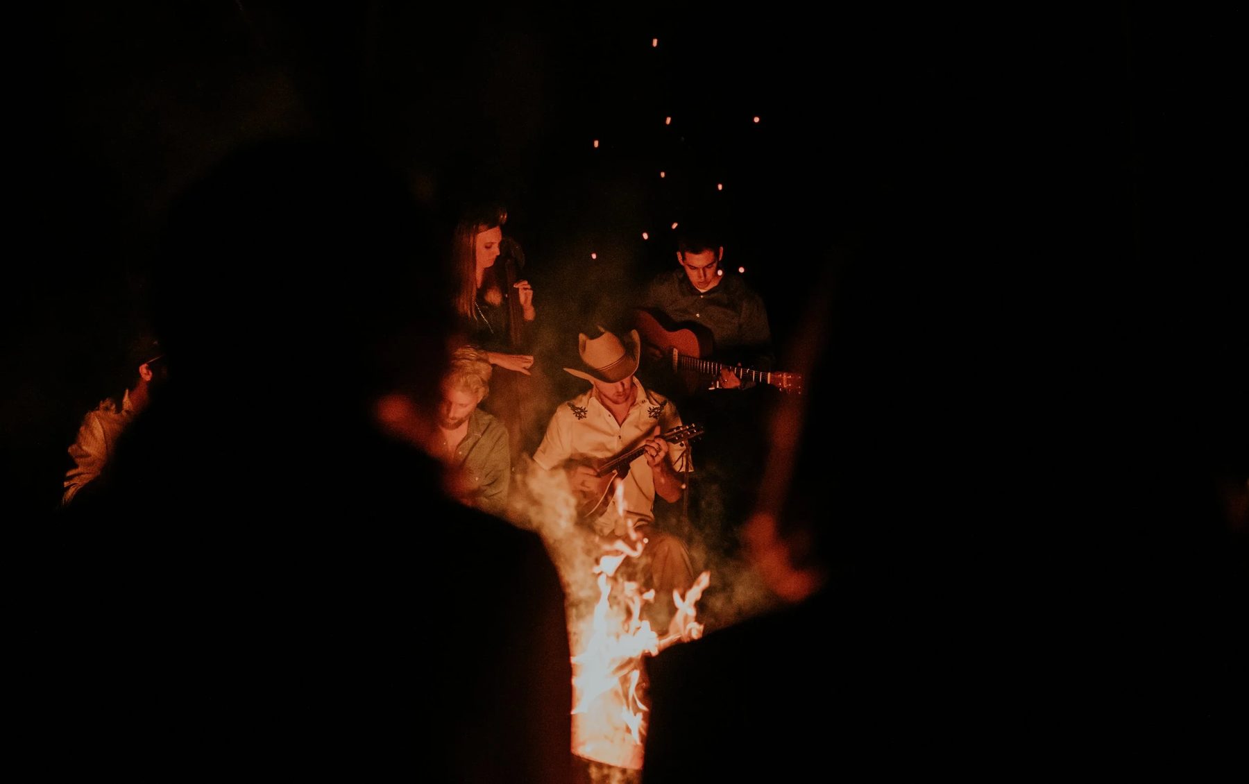 Musicians playing by firelight