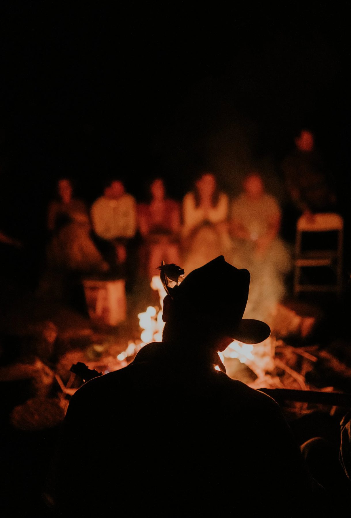 Silhouettes around a campfire