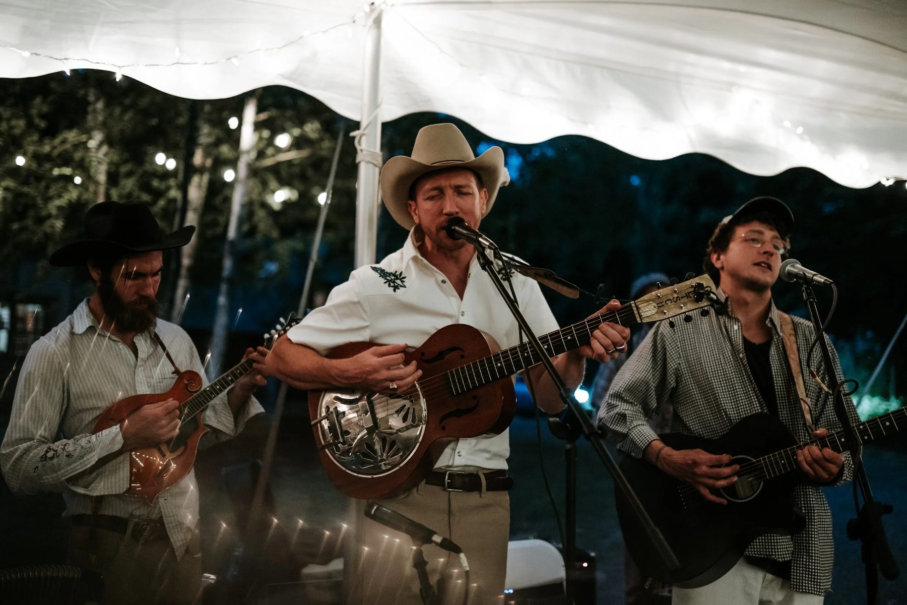 String band performing on stage under a tent