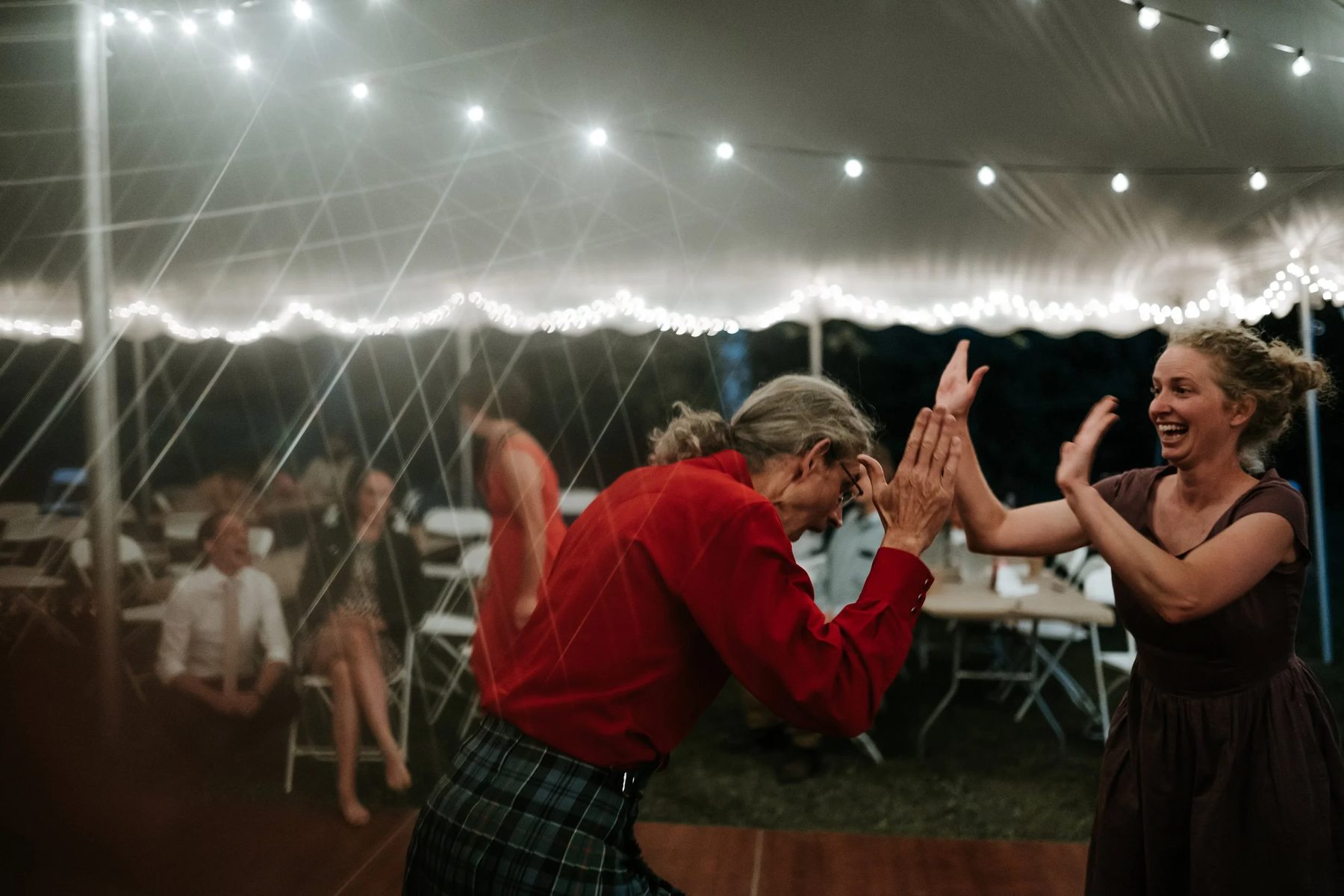 Two guests laughing on the dance floor